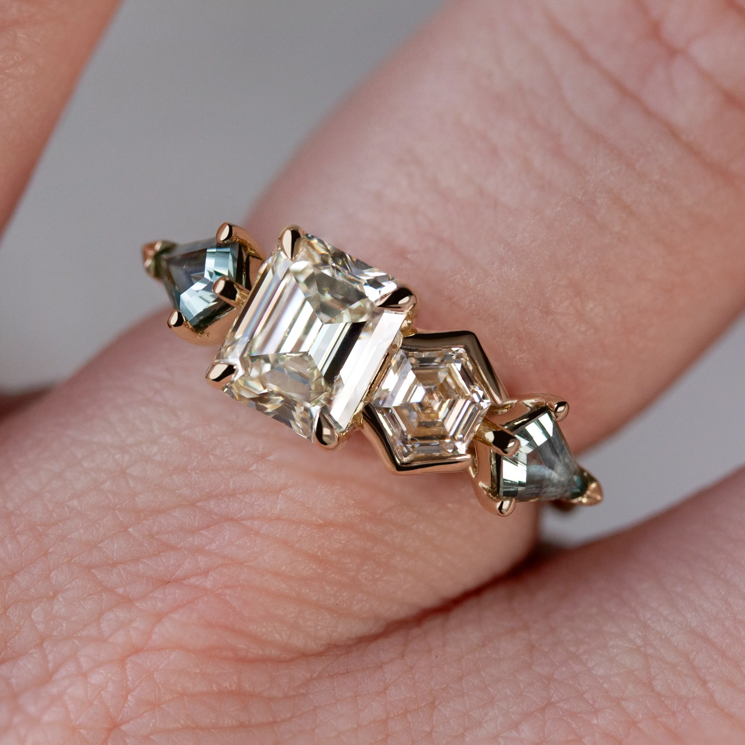 Custom Toi et Moi ring by Philadelphia's Emily Chelsea Jewelry with recycled diamonds, teal sapphires, and 14kt yellow gold.