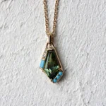 Custom Aura Necklace by Philadelphia's Emily Chelsea Jewelry, featuring a bi-color Australian sapphire, turquoise, diamonds, and 14kt yellow gold.