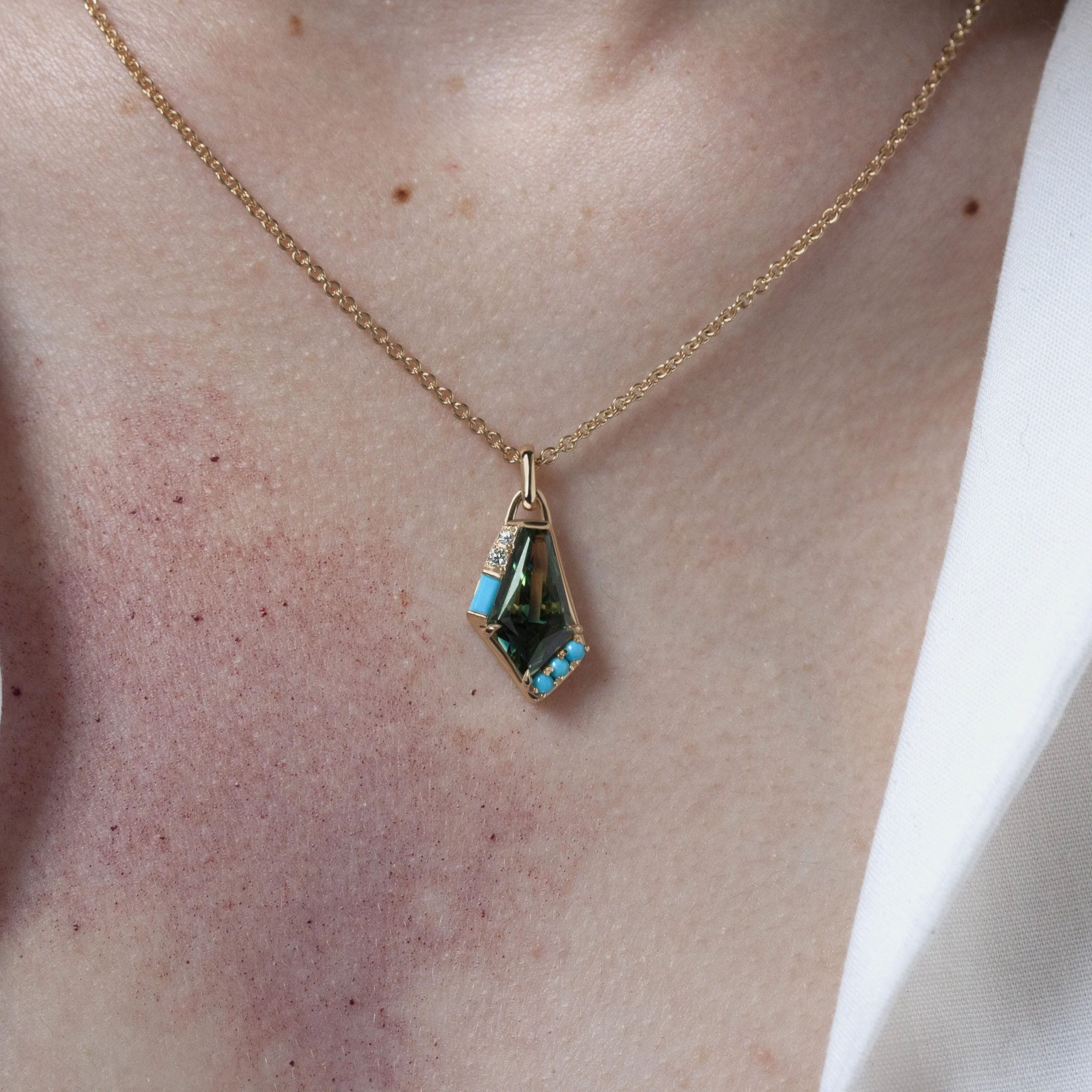 Custom Aura Necklace by Philadelphia's Emily Chelsea Jewelry, featuring a bi-color Australian sapphire, turquoise, diamonds, and 14kt yellow gold.