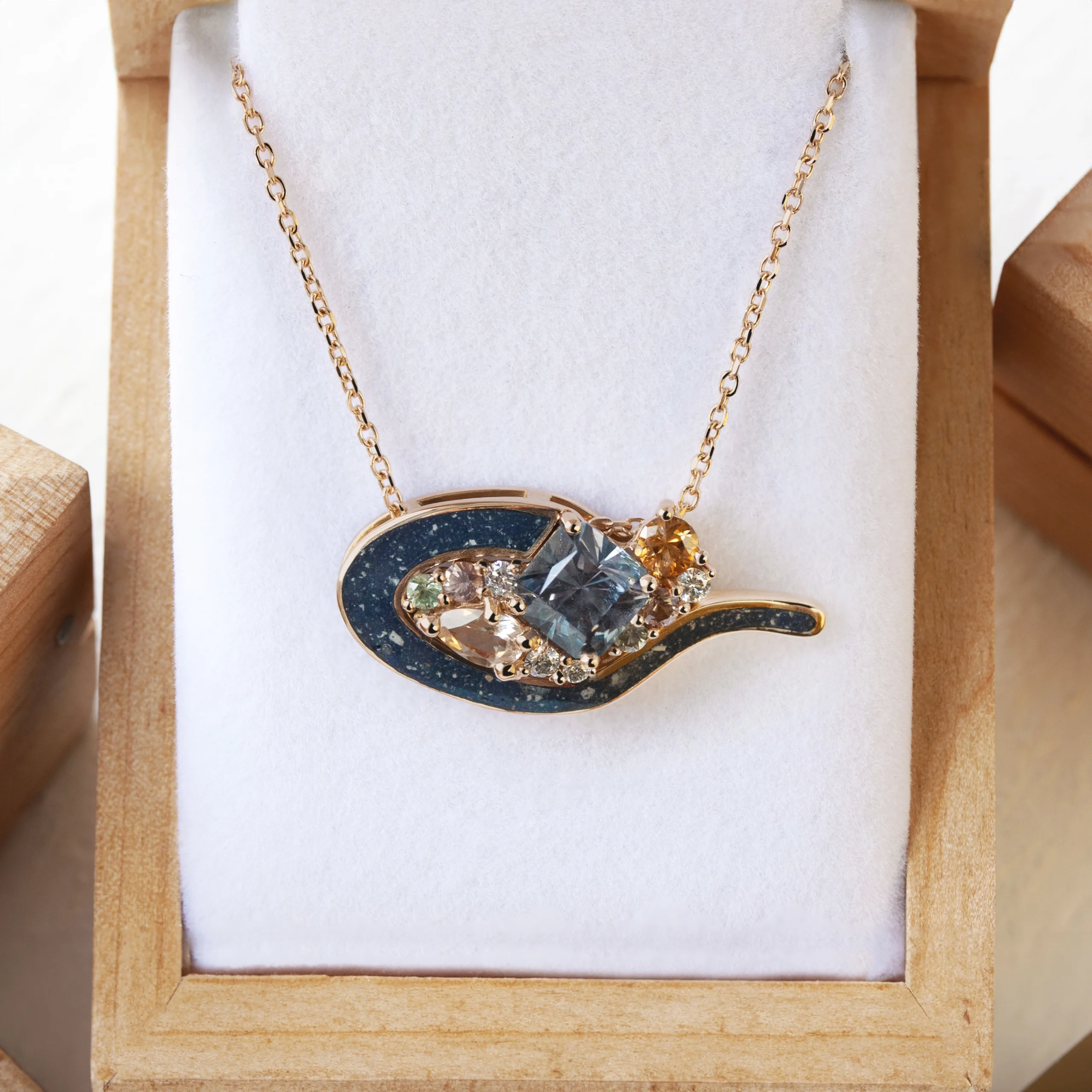Custom Evie the Cat pendant by Philadelphia local jeweler Emily Chelsea Jewelry with sapphires, diamonds, and ashes in 18kt rose gold.