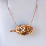 Custom Evie the Cat pendant by Philadelphia's Emily Chelsea Jewelry with sapphires, diamonds, and Evie's ashes in 18kt rose gold.
